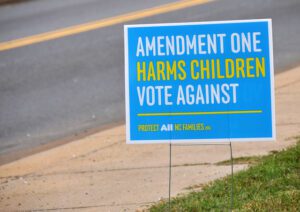 A sign that says amendment one harms children vote against.