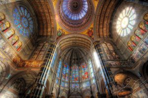 The inside of a cathedral with stained glass windows.