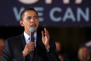 Obama speaks into a microphone at a campaign rally.