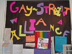 A bulletin board that says gay street alliance.