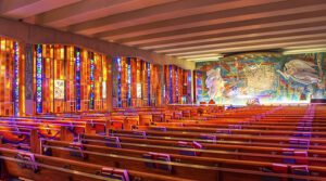 The interior of a church with colorful stained glass windows.