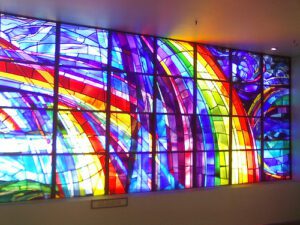 A colorful stained glass window in a room.