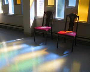 Two chairs in front of a window.