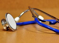 A blue stethoscope on a brown table.