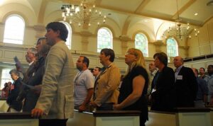 A group of people standing in a church.