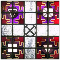 A stained glass window with various symbols on it.