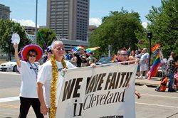 A group of people walking down the street holding a sign.