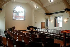 A large room with rows of chairs and a large window.