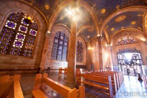 The interior of a church with stained glass windows.