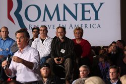 Romney speaks to a crowd of people at a campaign event.