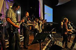 A group of people on stage at a concert.