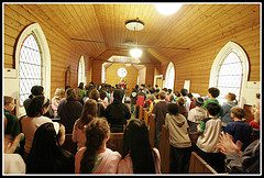 A group of people standing in a church.