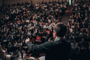 A man giving a presentation to a large audience.