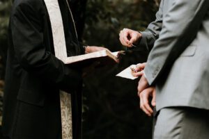 A man in a suit is holding a book.