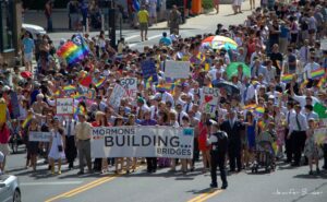 A group of people walking down a street holding signs.