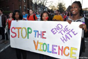 A group of people holding a sign that says end the hate violence.