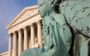 A statue of an angel in front of the supreme court.