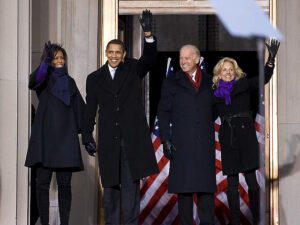 President obama and first lady michelle obama wave to the crowd.