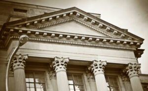 A black and white photo of a building with columns.