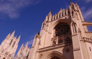 An ornate cathedral with spires and towers against a blue sky.