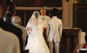 A bride and groom standing at the altar in a church.