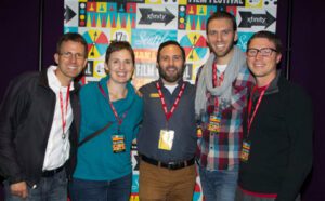 A group of people posing for a photo at an event.