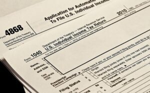 A stack of tax forms on a table.