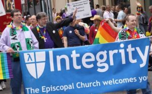 A group of people holding a banner that says integrity the episcopal church welcomes you.