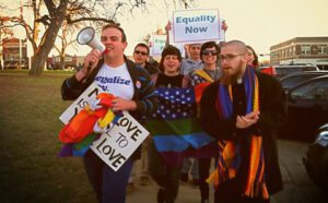 A group of people holding signs and a megaphone.