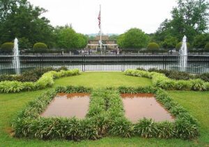 A fountain in the middle of a grassy area.