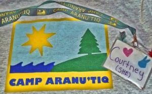 A t - shirt with a camp arnauti logo on it.