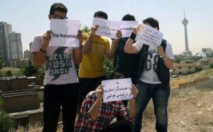 A group of young men holding signs in front of a city.