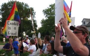 A group of people holding up signs and flags.