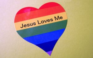 A rainbow heart with jesus loves me written on it.