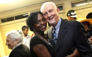 A man and woman posing for a photo at an event.