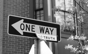 A black and white photo of a street sign.