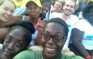 A group of people taking a selfie at an outdoor event.