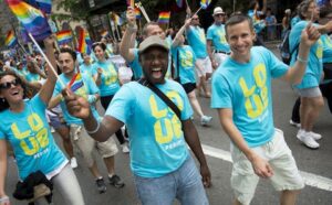 A group of people in blue t - shirts waving flags.