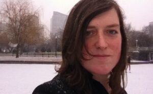 A woman in a park with snow on her face.