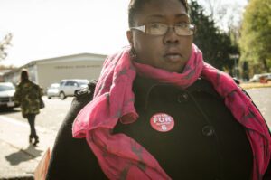 A woman wearing a pink scarf.