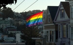A rainbow flag flies over a house in san francisco.