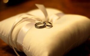 Two wedding rings on a pillow.
