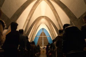 A group of people standing in a church.