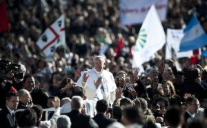 Pope john paul ii waves to a crowd of people.