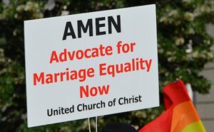 A sign that says amen advocate for marriage equality now.