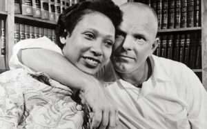 A black and white photo of a man and woman hugging.