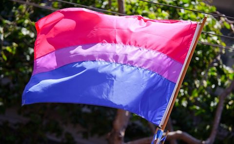 A flag with a pink, blue, and purple color.