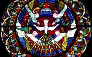 A stained glass window with a dove in the center.