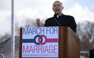 A priest giving a speech at a march for marriage.