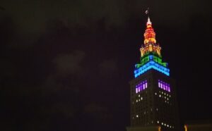 A tall building lit up in rainbow colors.